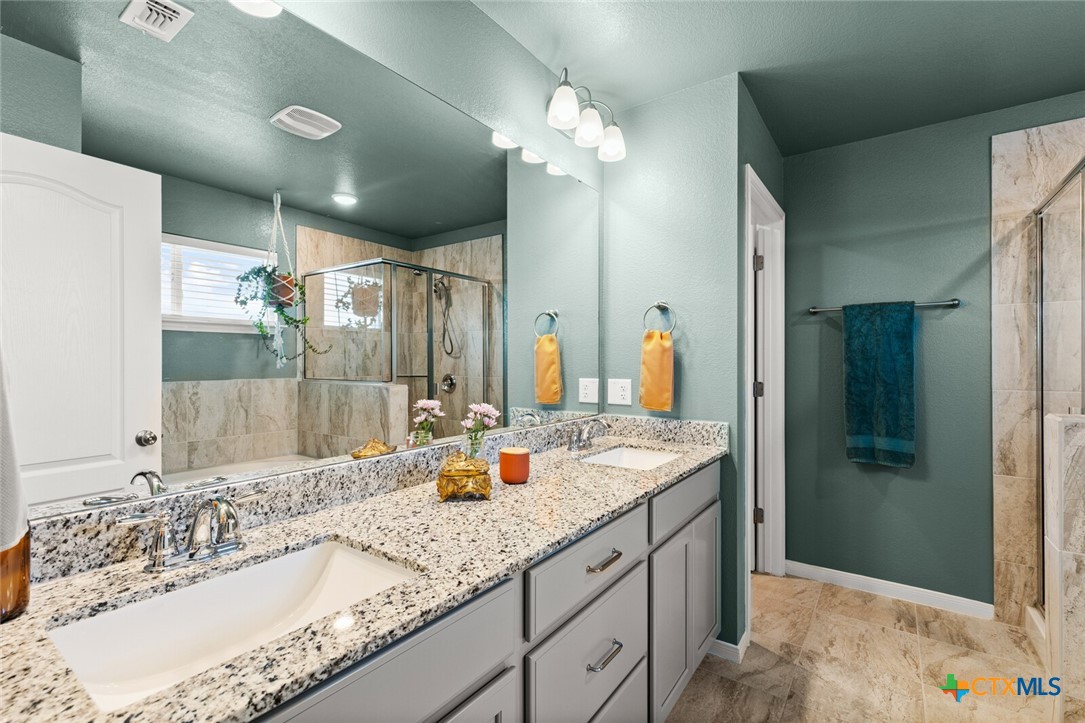 2233 Chia Court Temple, TX 76501 - Photo 34 of 47 a bathroom with a granite countertop double vanity sink and mirror