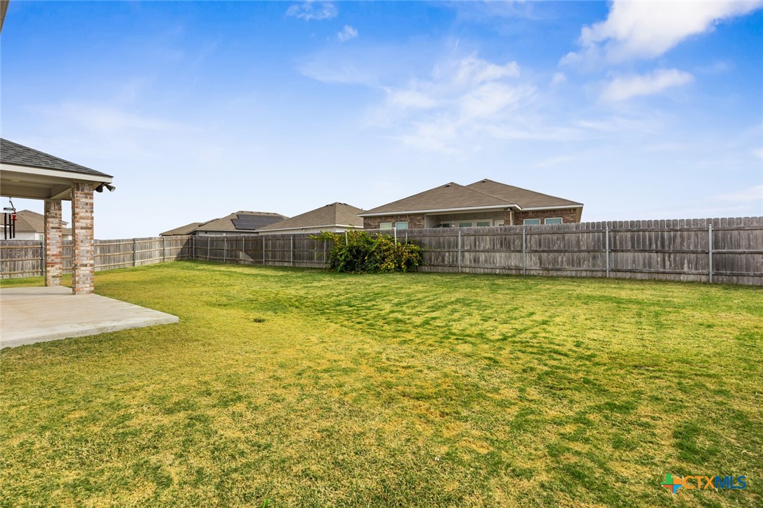 2233 Chia Court Temple, TX 76501 - Photo 46 of 47 a view of a large pool with lawn chairs under an umbrella