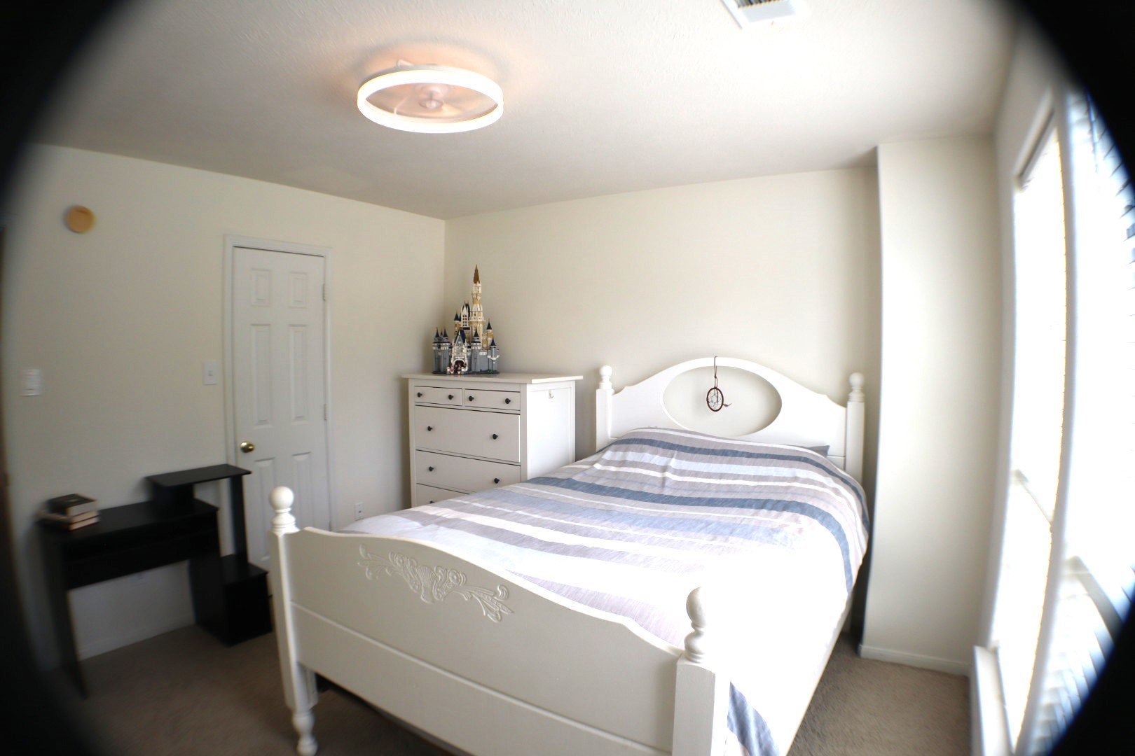 19114 Emory Trail Spring, TX 77388 - Photo 22 of 32 This is a cozy bedroom featuring a enough space for a bed, dresser, and a small desk. The room is well-lit with natural light from a large window and has a neutral wall color, creating a bright and airy atmosphere.
