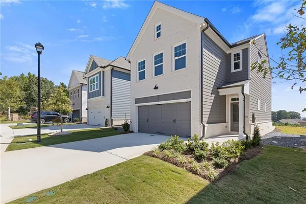 a front view of a house with a yard