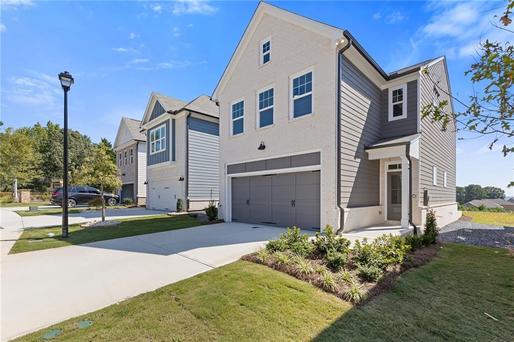 2716 Rylee Carter Street Dacula, GA 30019 - Photo 13 of 24 a front view of a house with a yard