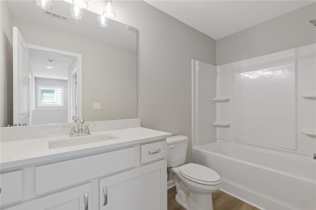 2716 Rylee Carter Street Dacula, GA 30019 - Photo 17 of 24 a bathroom with a sink toilet vanity and shower