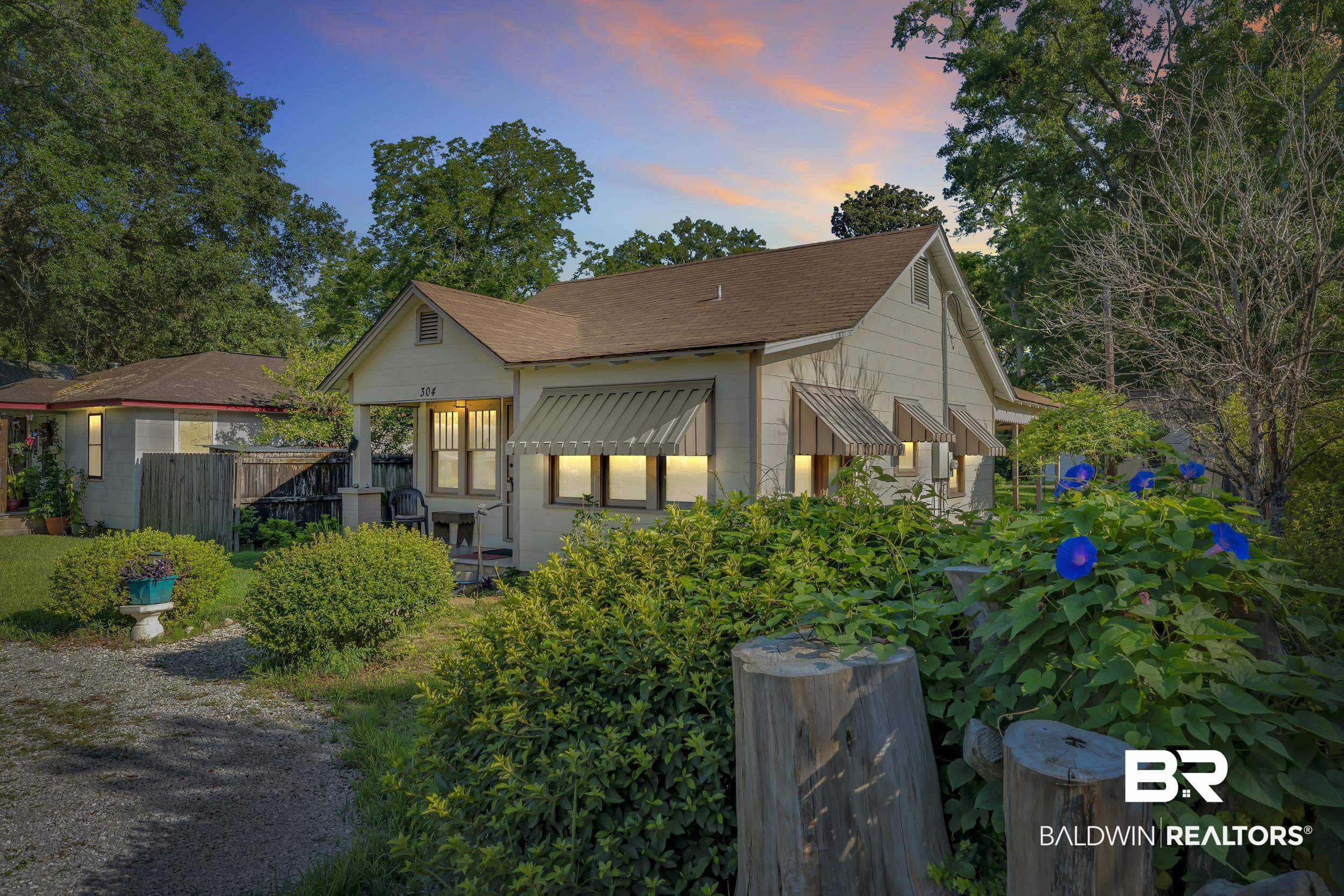 304 West Myrtle Avenue Foley, AL 36535 - Photo 28 of 29 Single-story bungalow with light-colored siding and a gabled roof