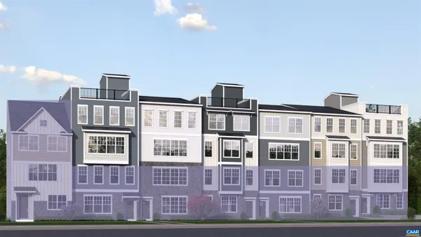 a front view of a residential apartment building with a yard