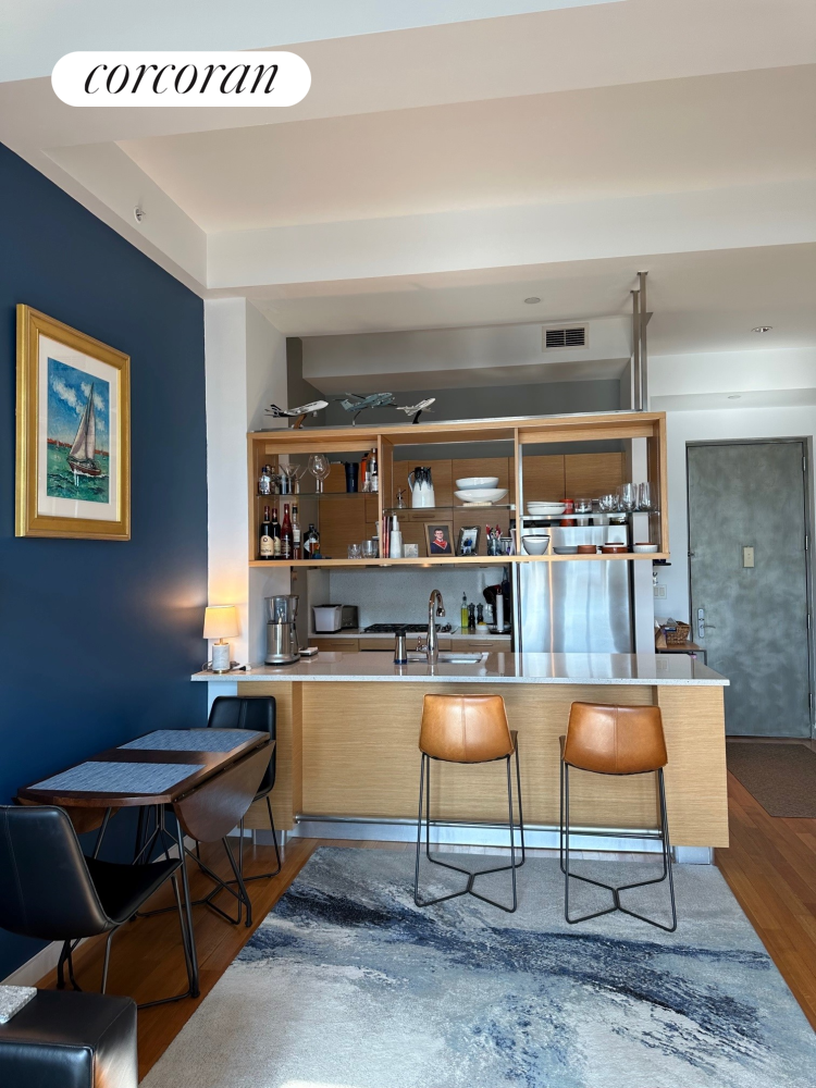85 Adams Street, Unit 14C Brooklyn, NY 11201 - Photo 2 of 12 a living room with a table a table and kitchen view
