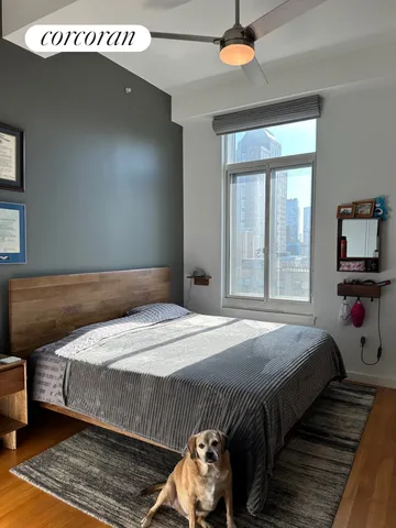 a bedroom with a bed and a large window