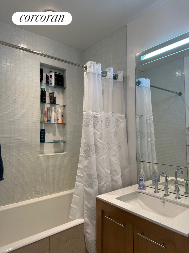 85 Adams Street, Unit 14C Brooklyn, NY 11201 - Photo 7 of 12 a bathroom with a sink and a mirror