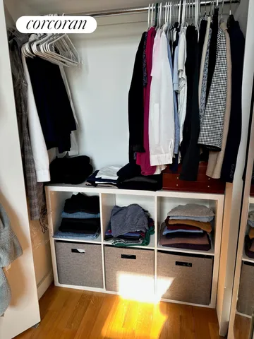 a view of walk in closet with clothes and shoes