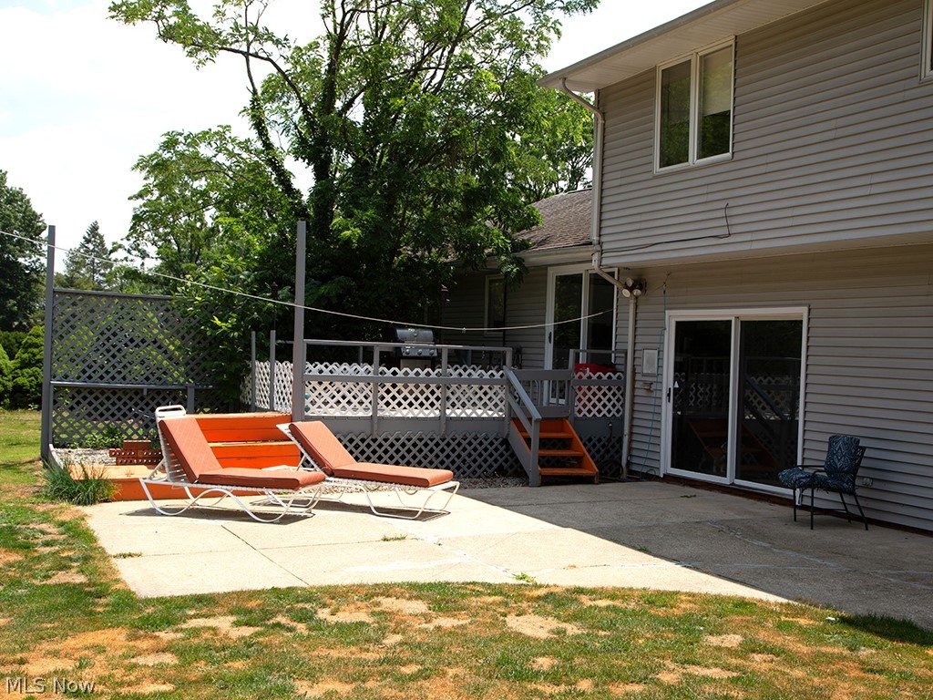 29399 Bryce Road Cleveland, OH 44124 - Photo 25 of 31 Rear view of house featuring a private yard with a lawn, deck and a patio