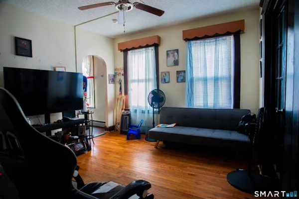 a living room with furniture and a flat screen tv