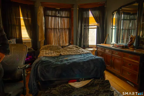 a bed sitting in a bedroom next to a window