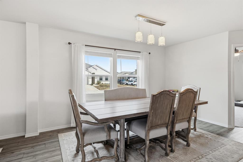16041 Pious Drive Haslet, TX 76052 - Photo 11 of 36 a view of a dining room with furniture window and wooden floor