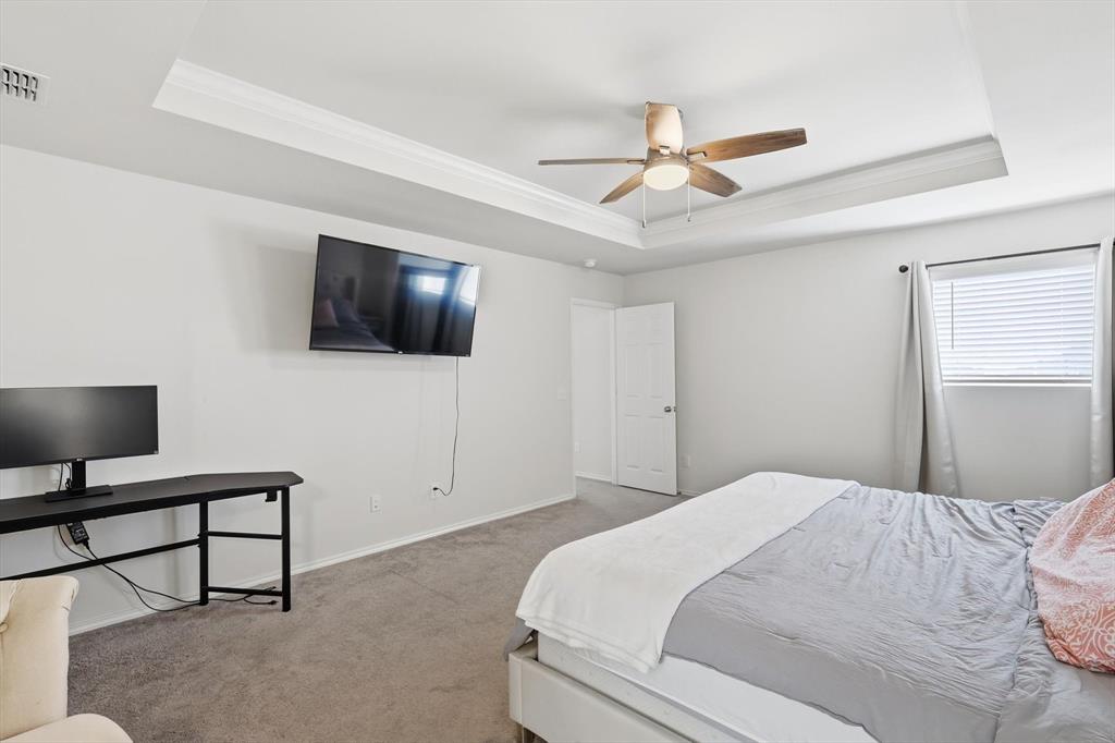 16041 Pious Drive Haslet, TX 76052 - Photo 16 of 36 a bedroom with a bed tv and a window