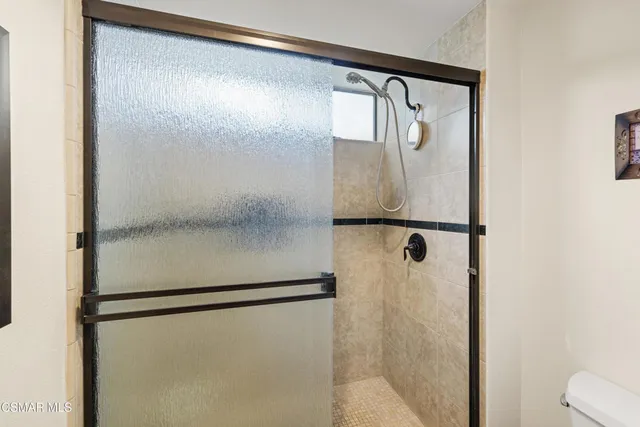 a bathroom with a glass shower door