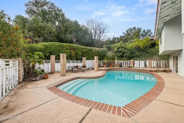 a view of a swimming pool with a patio