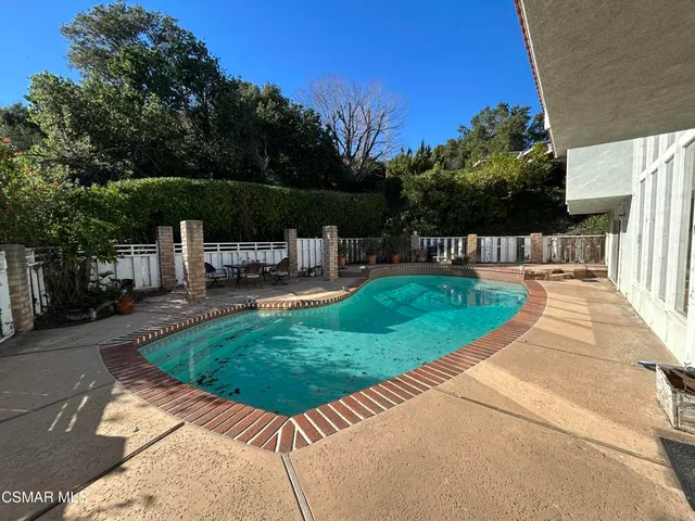 a view of a backyard with sitting area