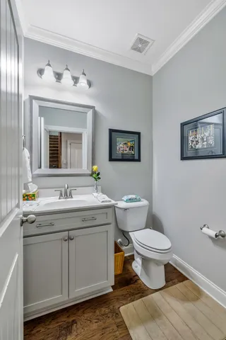 a living room with furniture a chandelier and a flat screen tv