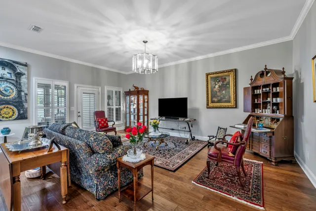 a living room with furniture and a chandelier