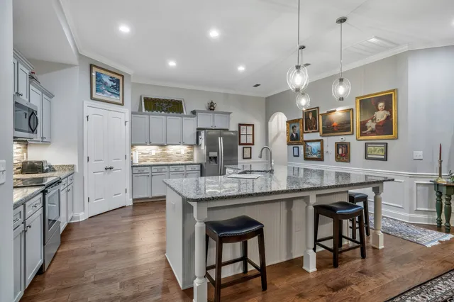 a kitchen with sink stove and refrigerator