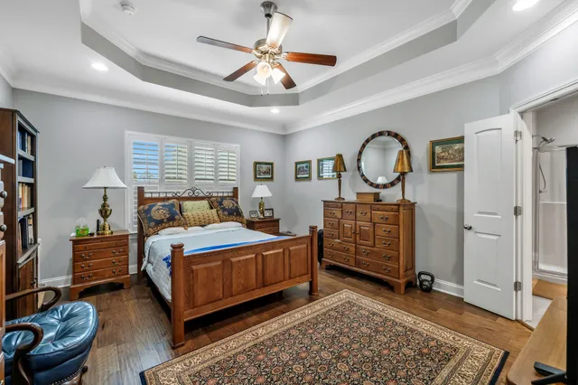 a spacious bathroom with a granite countertop sink a toilet and a large mirror