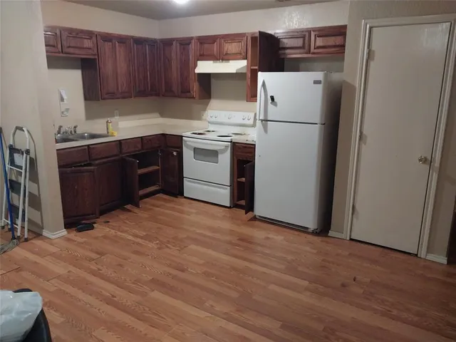 a kitchen with a refrigerator and a stove