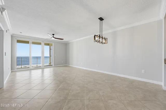 a dining room with furniture a rug and a chandelier