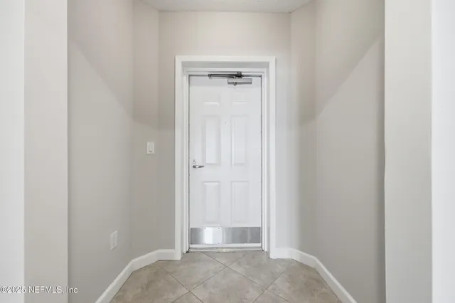 a view of a hallway with a wooden shelves