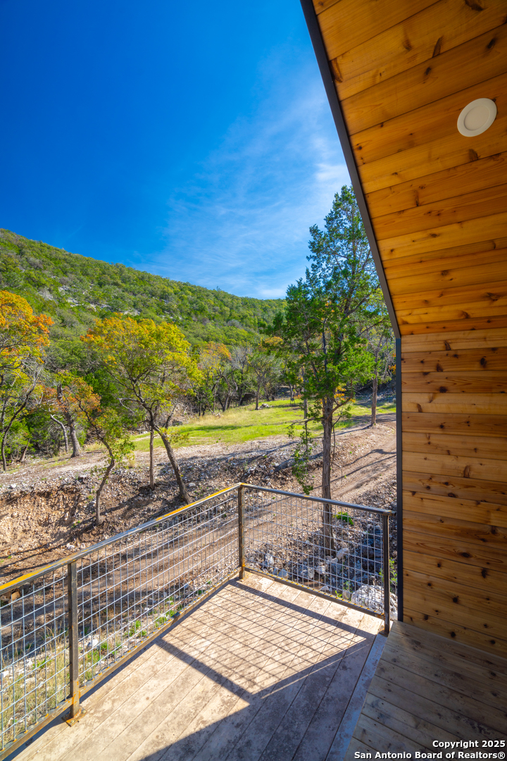 83 Leakey Tx 78873 Leakey, TX 78873 - Photo 15 of 38 a view of a swimming pool with a lounge chairs