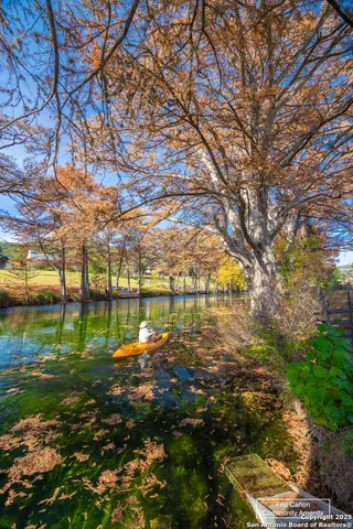 a living room with furniture fireplace and a large window