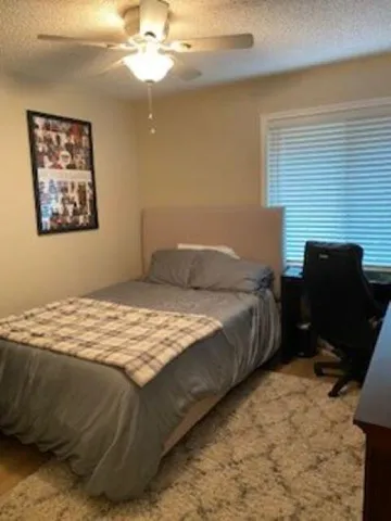a bedroom with a bed and a chair