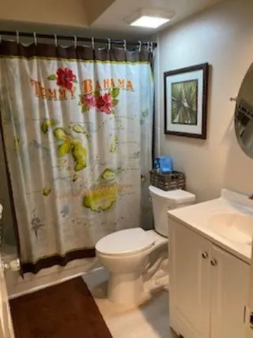 a bathroom with a shower toilet and sink
