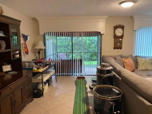 a living room with furniture and a floor to ceiling window