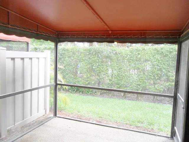 a view of a room with a green space and outdoor view