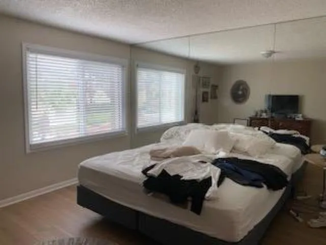 a bedroom with a bed and window