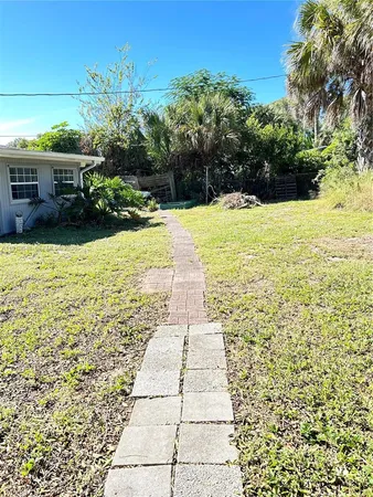 a view of a house with a tree in the yard