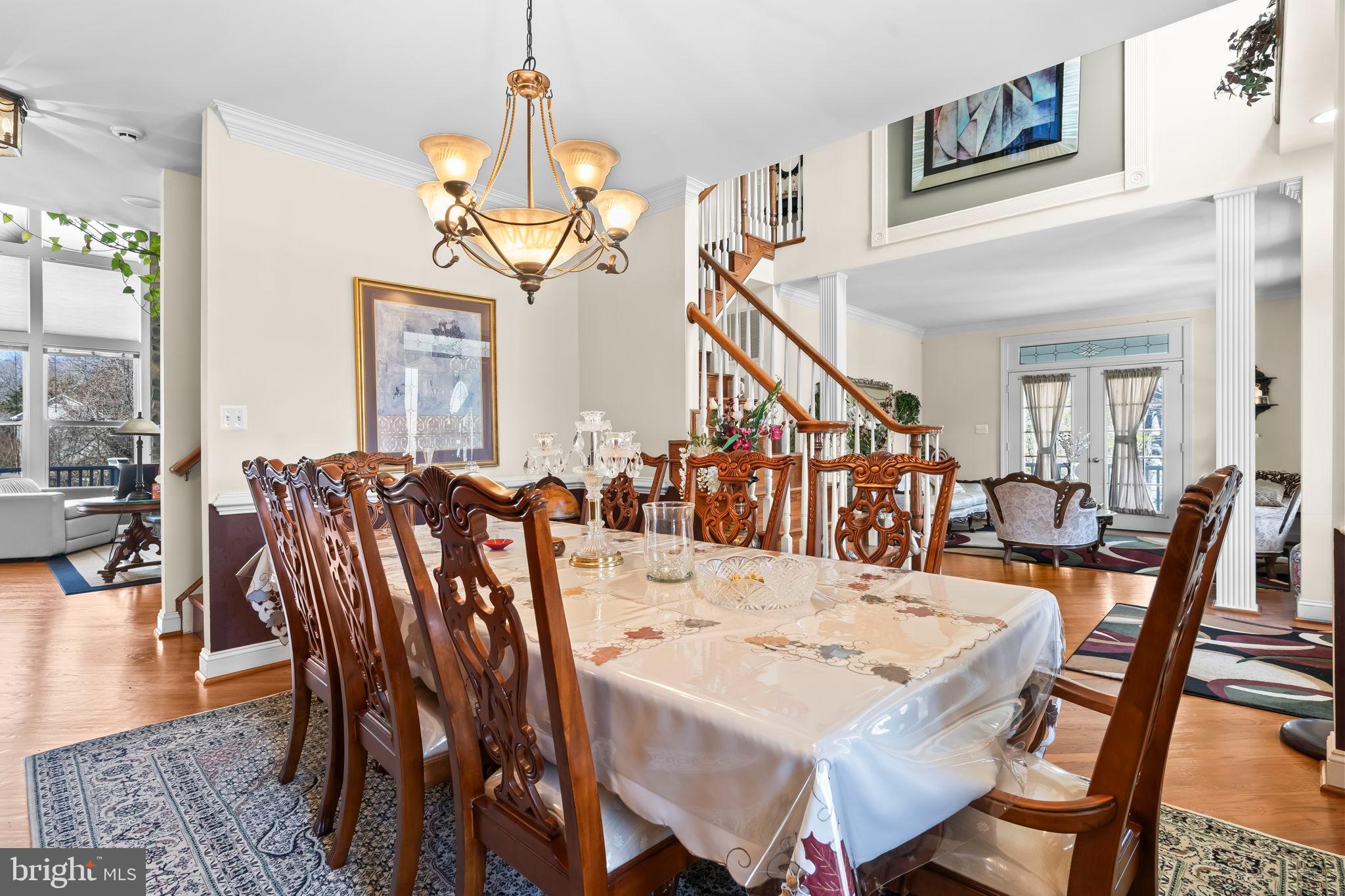 5 Cross Point Drive Owings, MD 20736 - Photo 13 of 63 a view of a dining room and livingroom with furniture wooden floor a rug a chandelier and a view