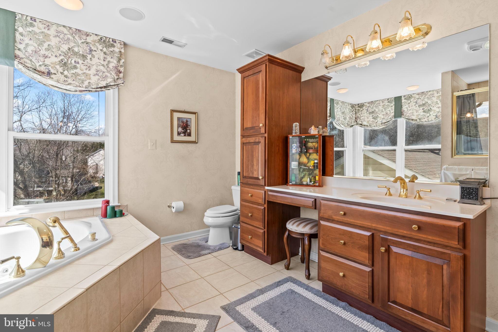 5 Cross Point Drive Owings, MD 20736 - Photo 22 of 63 a spacious bathroom with a granite countertop double vanity sink mirror bathtub and toilet