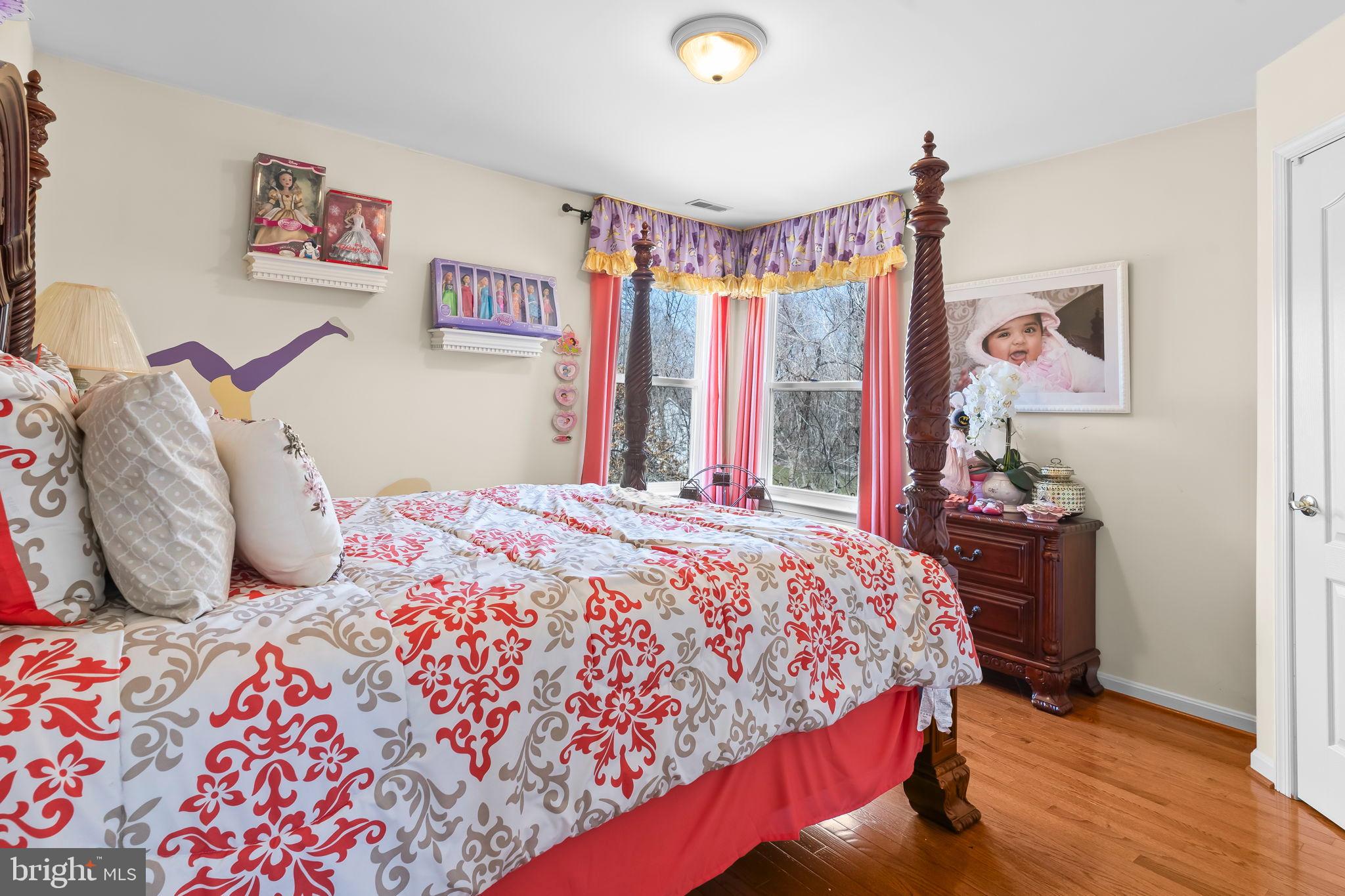 5 Cross Point Drive Owings, MD 20736 - Photo 28 of 63 a bedroom with a bed and a chandelier