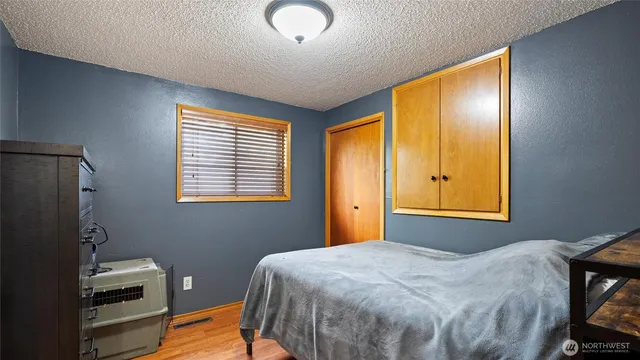 a bedroom with a bed and a chandelier