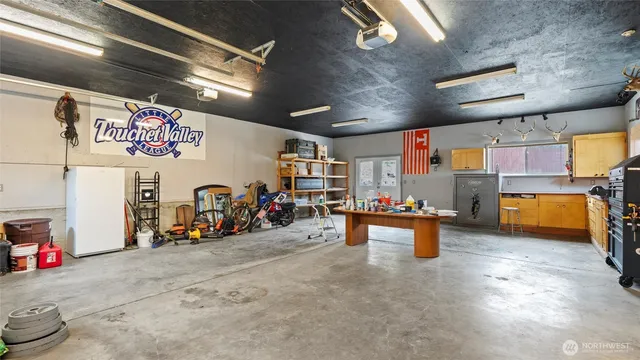 a view of a backyard with table and chairs with wooden fence