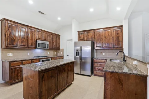 a view of a room with wooden floor and white walls
