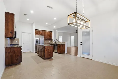 a kitchen with stainless steel appliances granite countertop a stove a sink a refrigerator and a oven