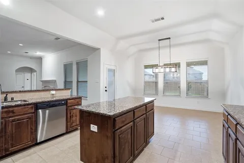 a view of a kitchen with a sink and a refrigerator