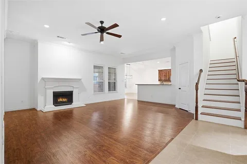 an empty room with windows and fireplace