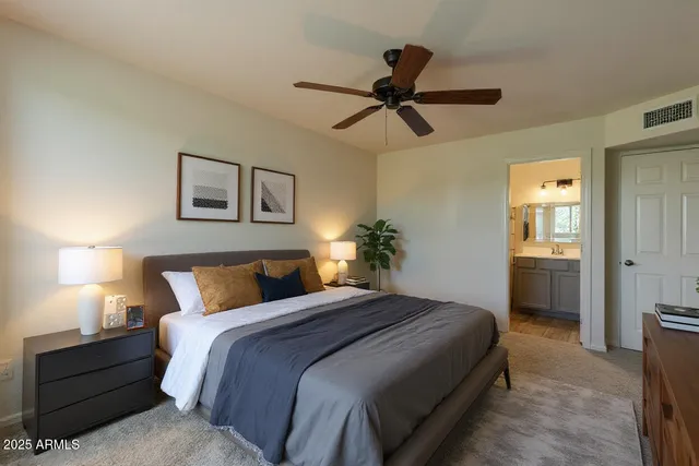 a bedroom with a bed and a chandelier