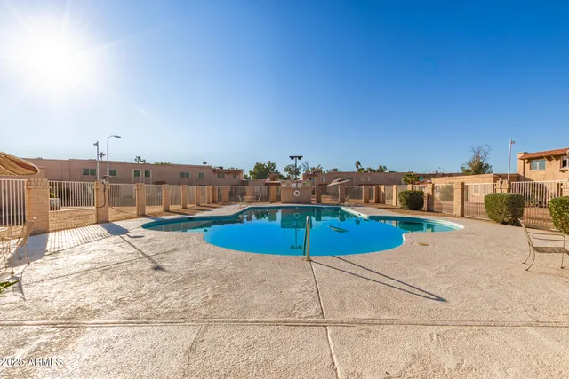 a view of a swimming pool and a yard