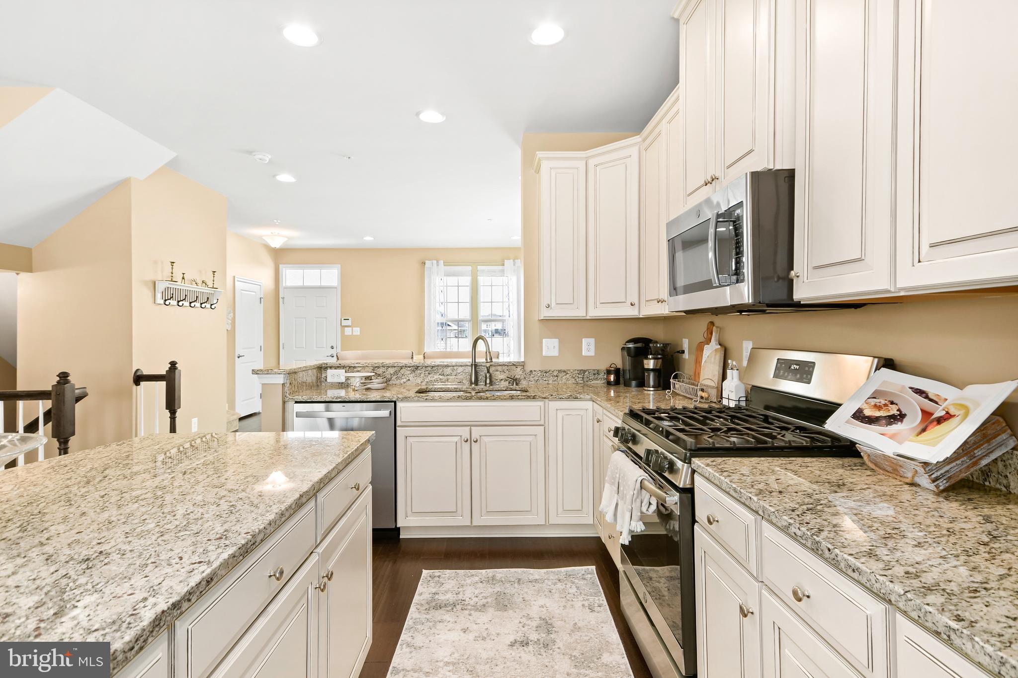 4502 Tinder Monrovia, MD 21770 - Photo 25 of 62 a kitchen with stainless steel appliances granite countertop a stove a sink and a white cabinets