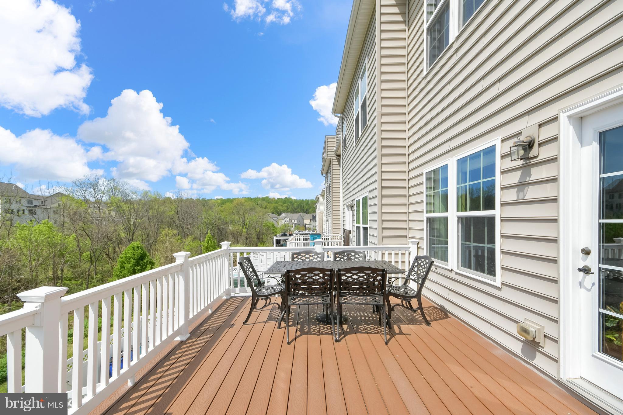 4502 Tinder Monrovia, MD 21770 - Photo 34 of 62 a view of a roof deck with table and chairs and wooden floor
