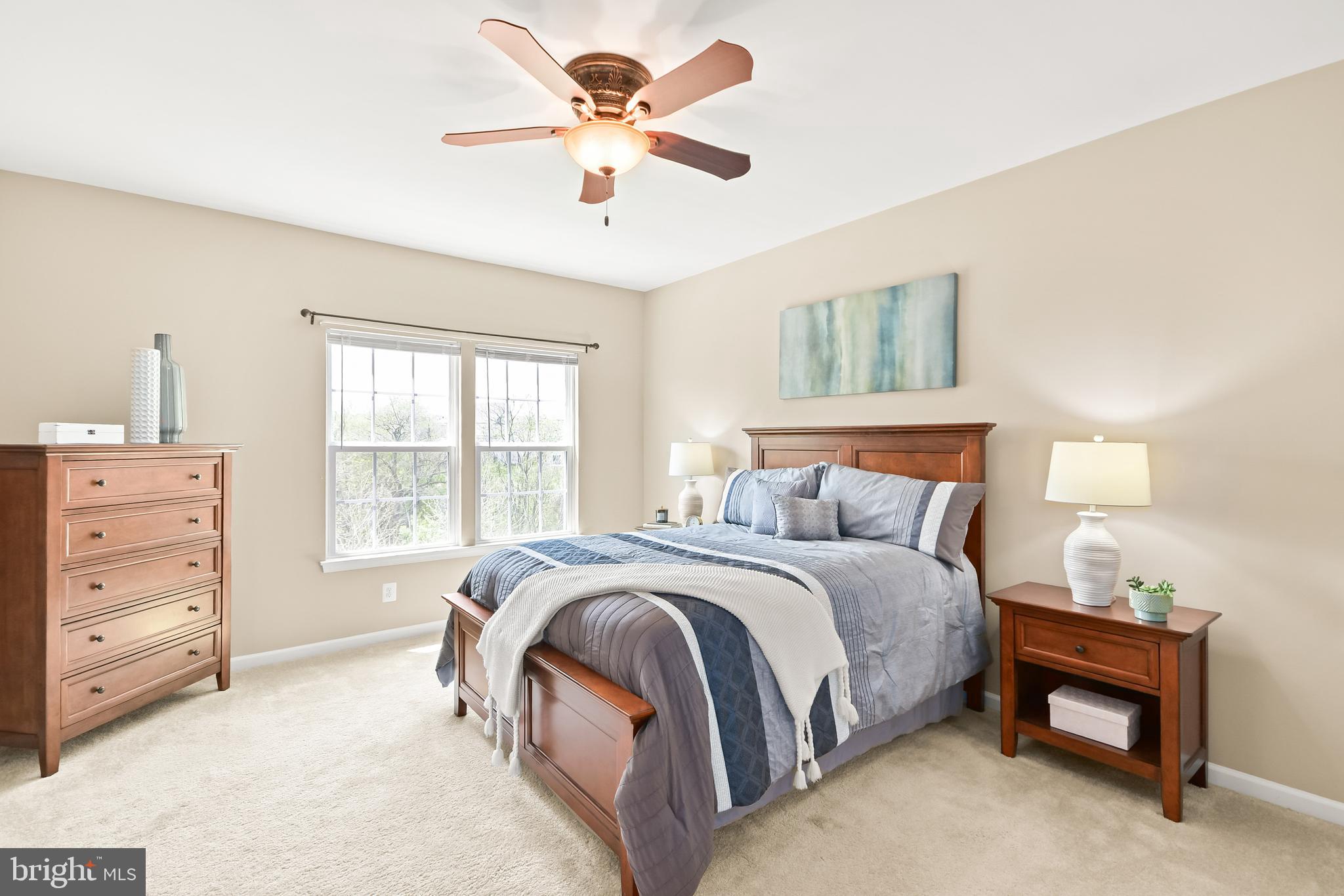 4502 Tinder Monrovia, MD 21770 - Photo 7 of 62 a spacious bedroom with a bed a dresser and a chandelier