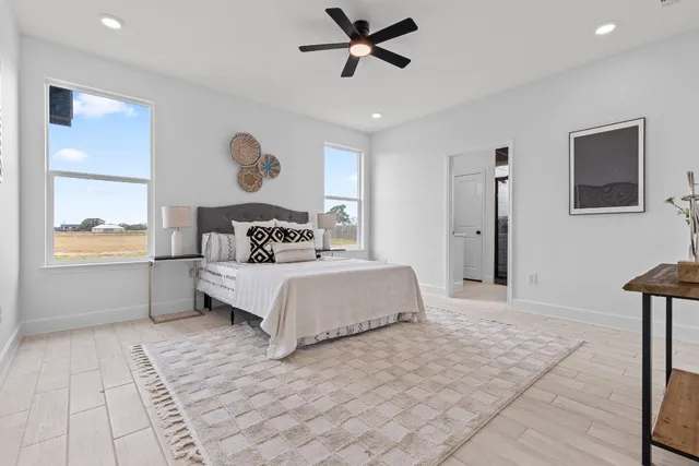 a bedroom with a large bed and a chandelier